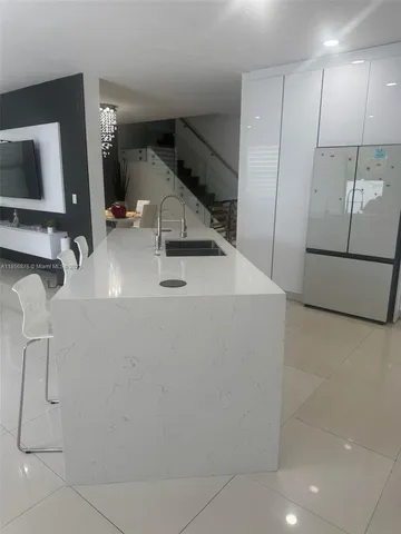 a kitchen with white cabinets and a stove