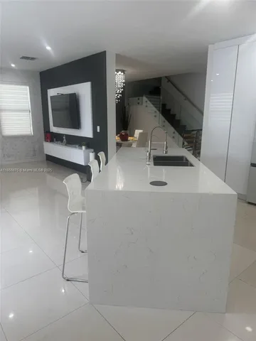 a kitchen with stainless steel appliances white cabinets and a stove