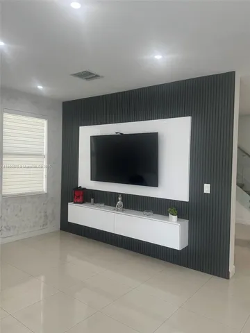 a living room with flat screen tv
