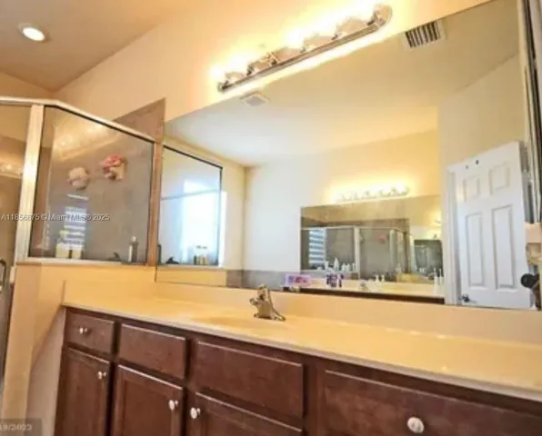 a bedroom with a bed and flat screen tv