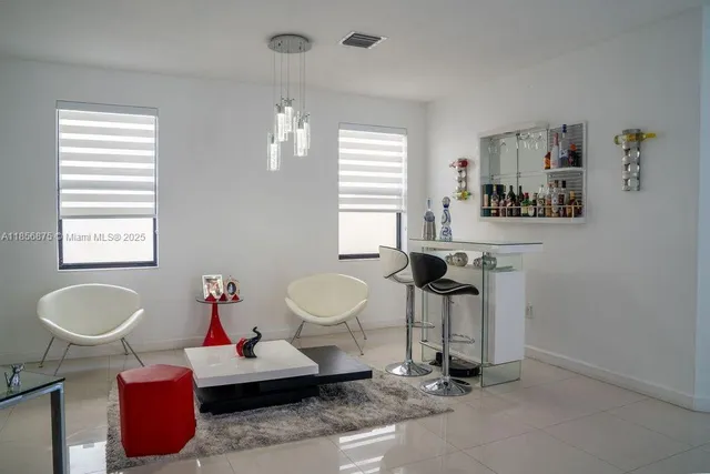 a living room with furniture a window and gym equipment