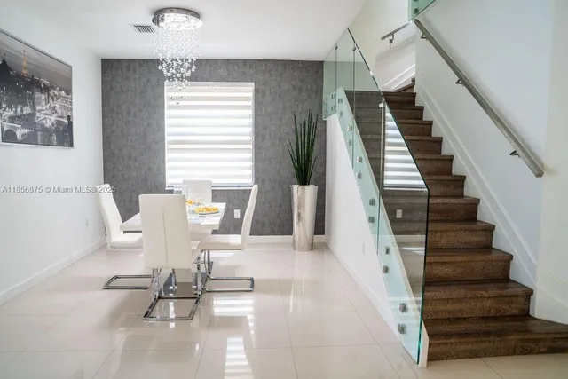 a view of hall way with furniture and stairs