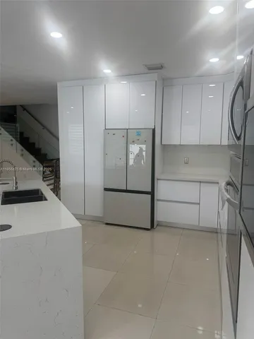 a kitchen with stainless steel appliances a sink and a stove