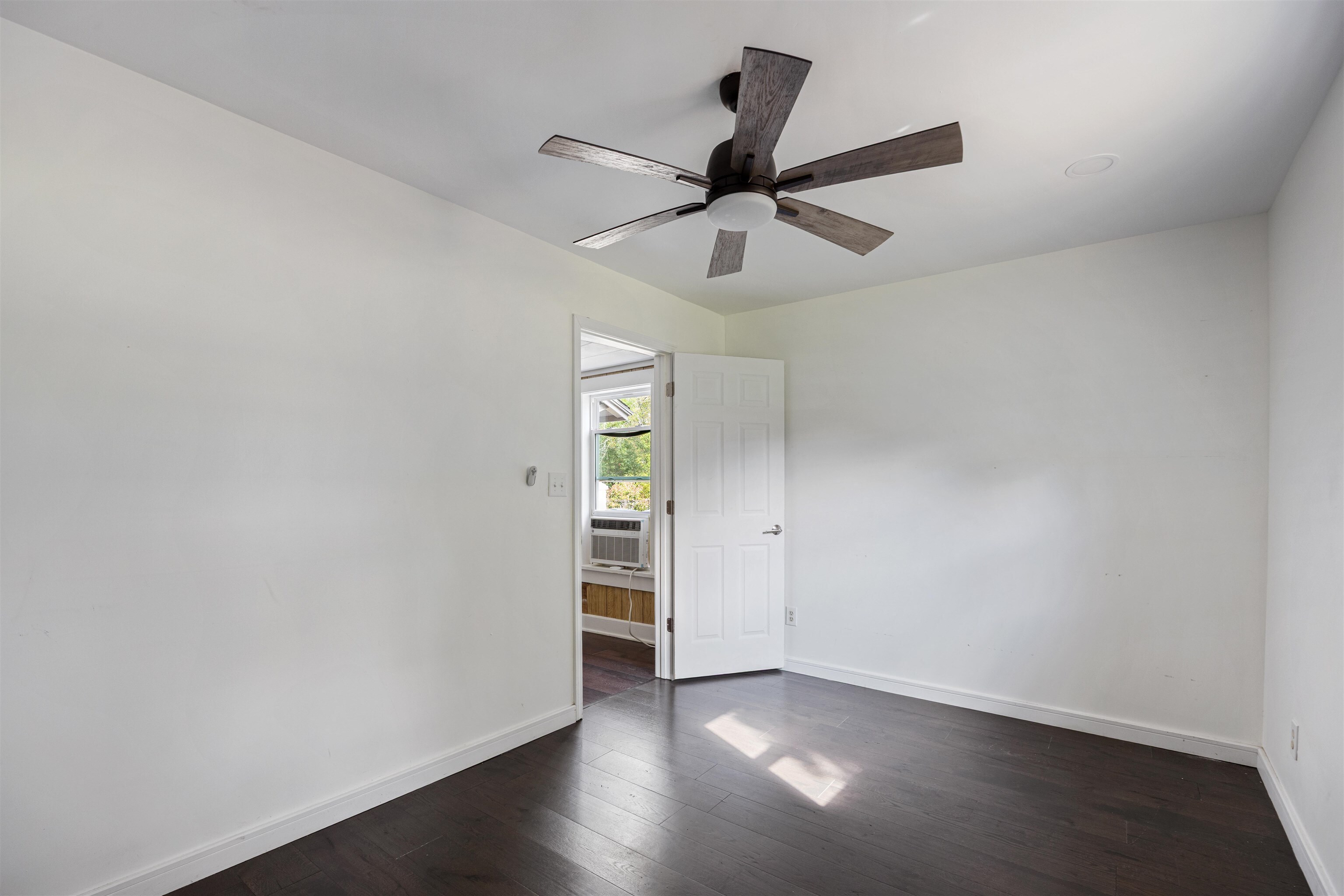 112 South Juniper Street Foley, AL 36535 - Photo 7 of 64 Spare room featuring dark wood-style flooring and a ceiling fan