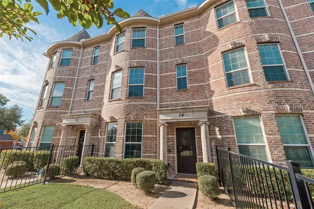 a view of a brick building next to a yard