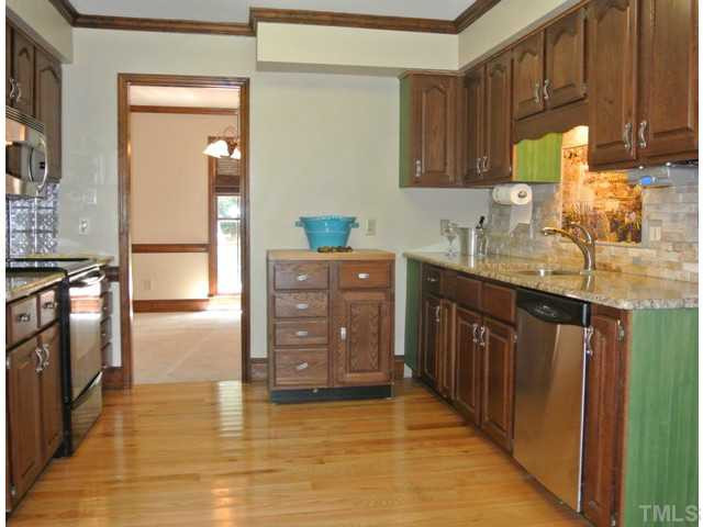 2215 Yorkgate Drive Raleigh, NC 27612 - Photo 8 of 24 The kitchen provides great work space, has granite counter tops, a tile back splash with decorative accents above the sink and a tin back splash on the stove side. Kitchen
