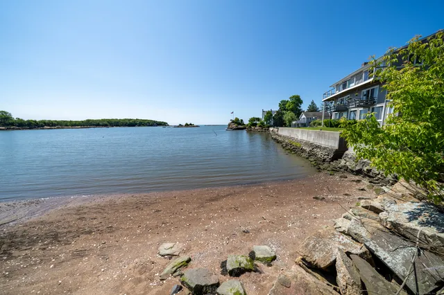 a view of a lake with beach and lake in the back