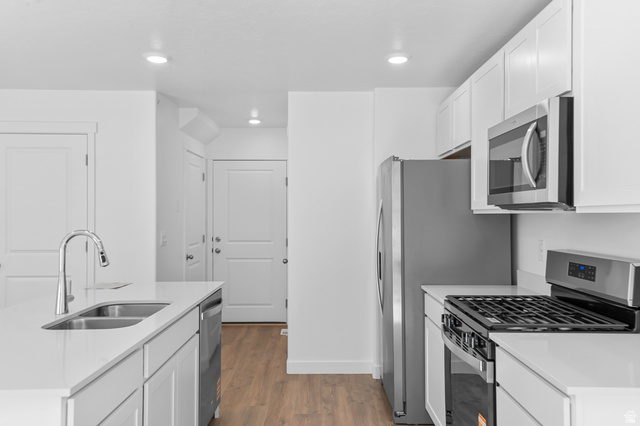 1907 East 640th North, Unit 1225 Salem, UT 84653 - Photo 20 of 20 Modern kitchen featuring white cabinetry, light countertops, wood-finish flooring, stainless steel appliances, and recessed lighting