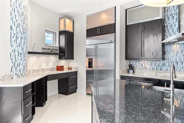 a kitchen with stainless steel appliances granite countertop a sink and cabinets