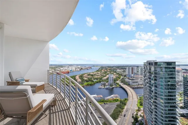 a bathroom with a granite countertop sink toilet and mirror