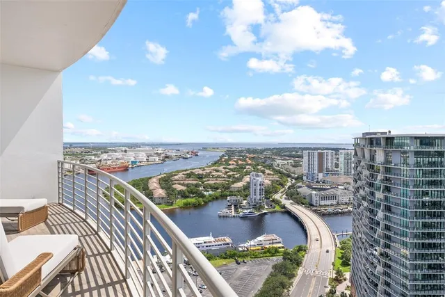 a large bedroom with a large bed and a large window
