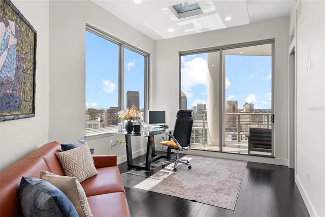 a bedroom with a large bed and a flat tv screen