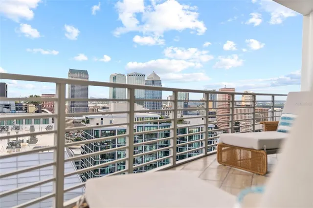 a living room with a bed furniture and a large window