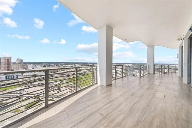 a bedroom with a bed and a flat tv screen on dresser