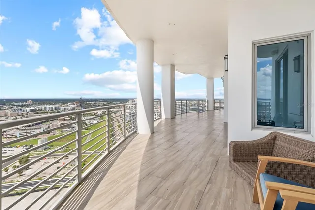 a bedroom with a large bed and a large window