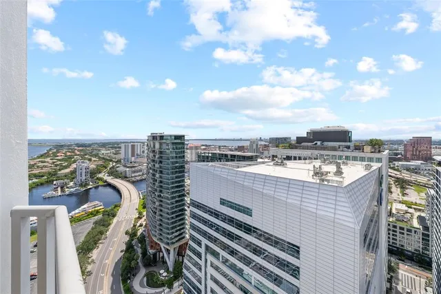 a bedroom with a bed and large window