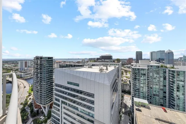 a swimming pool with outdoor seating and city view