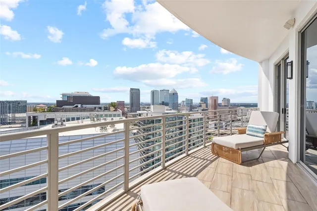 a view of a patio with a table and chairs and potted plants
