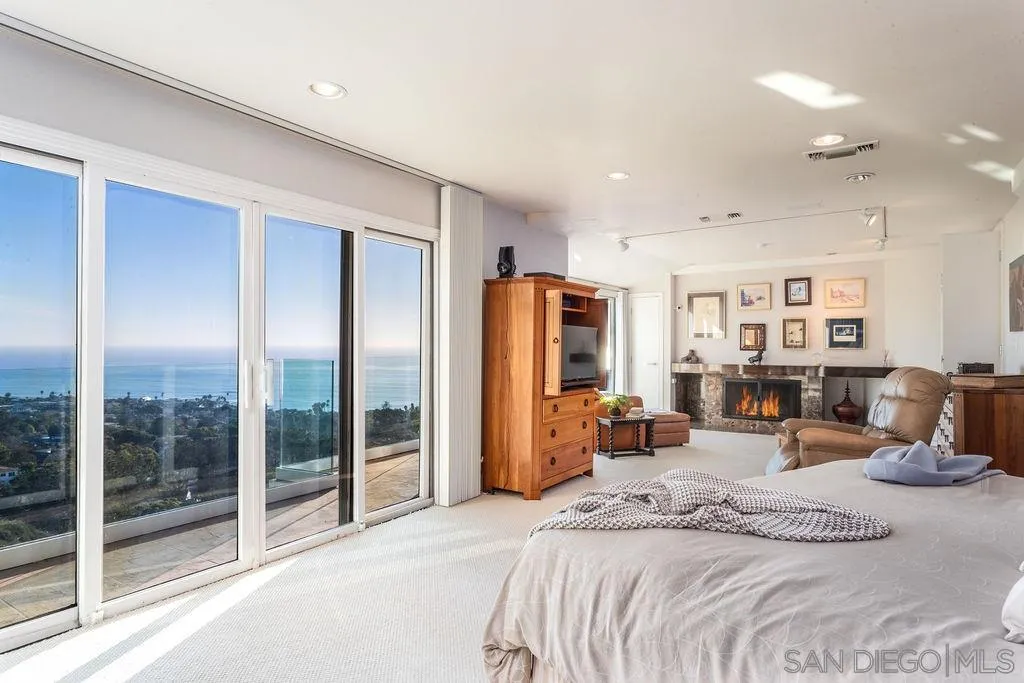 925 Havenhurst Drive La Jolla, CA 92037 - Photo 7 of 17 a bed room with a bed and glass door