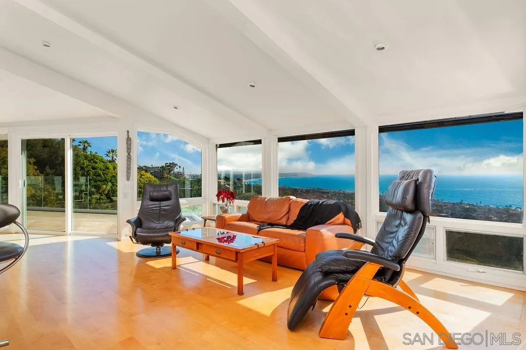 925 Havenhurst Drive La Jolla, CA 92037 - Photo 8 of 17 a living room with furniture and a floor to ceiling window