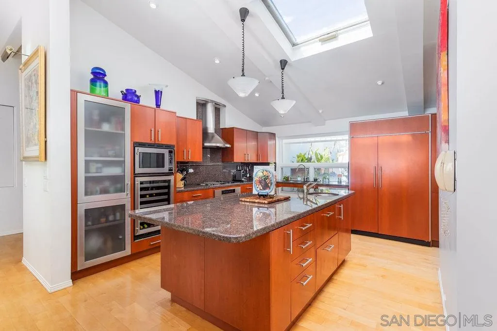 925 Havenhurst Drive La Jolla, CA 92037 - Photo 9 of 17 a kitchen with stainless steel appliances granite countertop a stove and a refrigerator