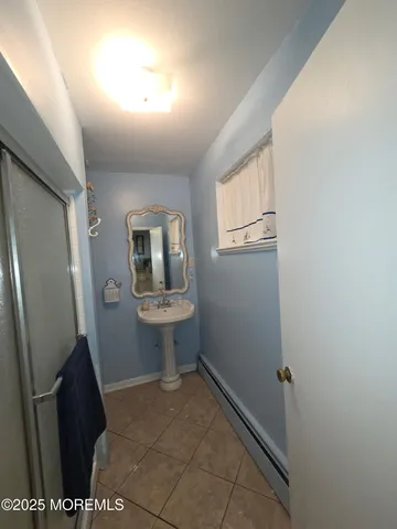 a bathroom with a granite countertop sink vanity and mirror