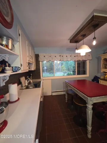 a room with pool table and windows