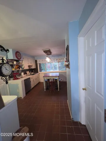 a kitchen with a sink a stove and cabinets