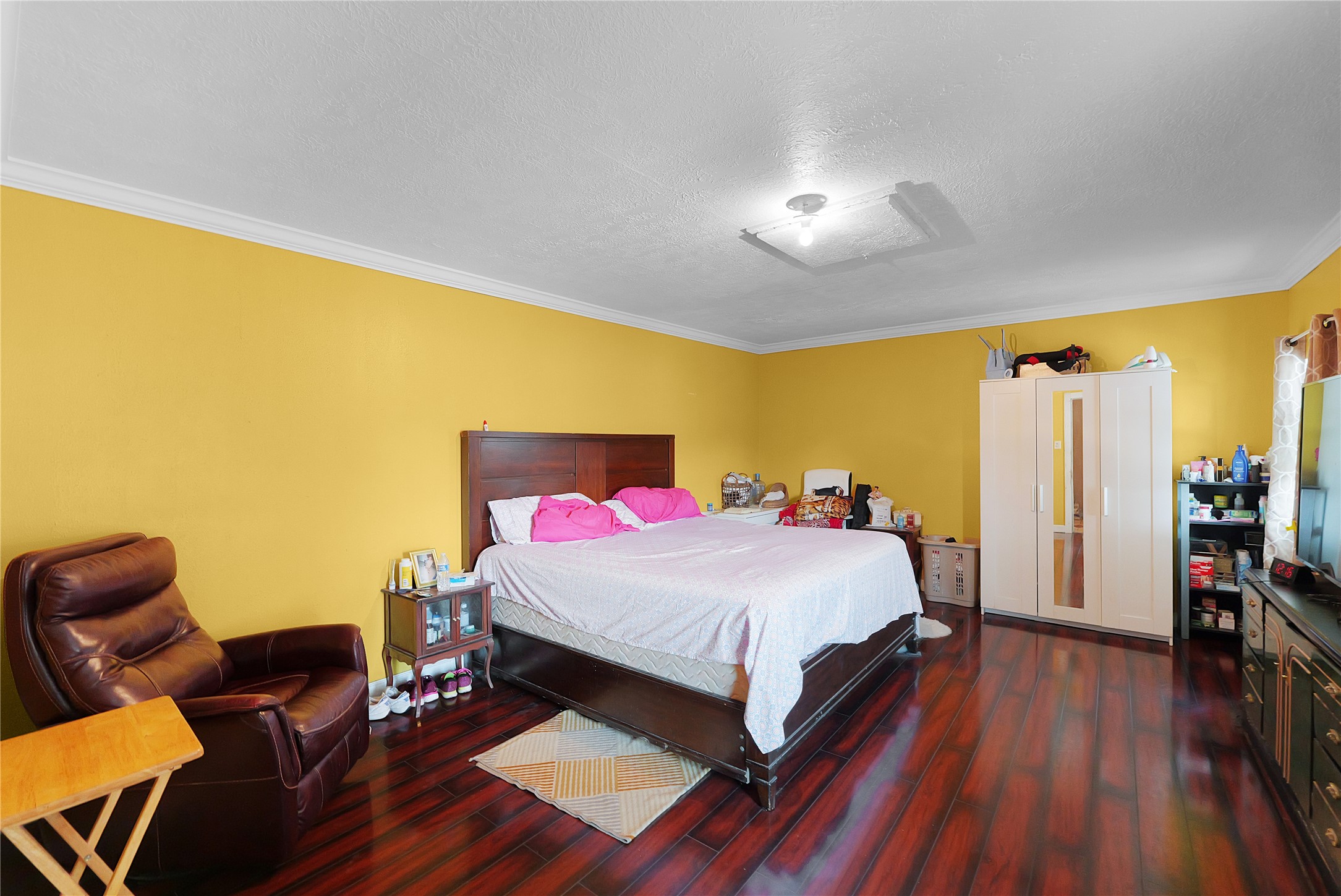 7525 Canal Street Houston, TX 77012 - Photo 11 of 18 a bedroom with a bed and wooden floor