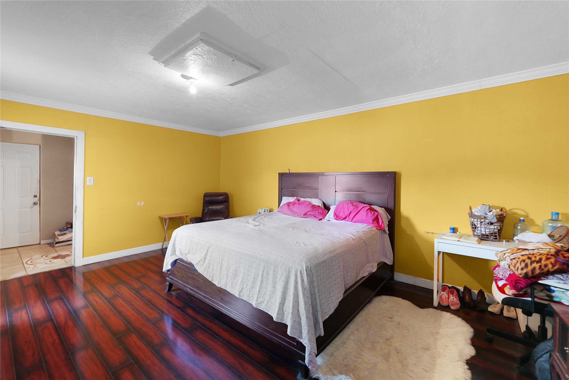 7525 Canal Street Houston, TX 77012 - Photo 12 of 18 a bedroom with a bed and wooden floor