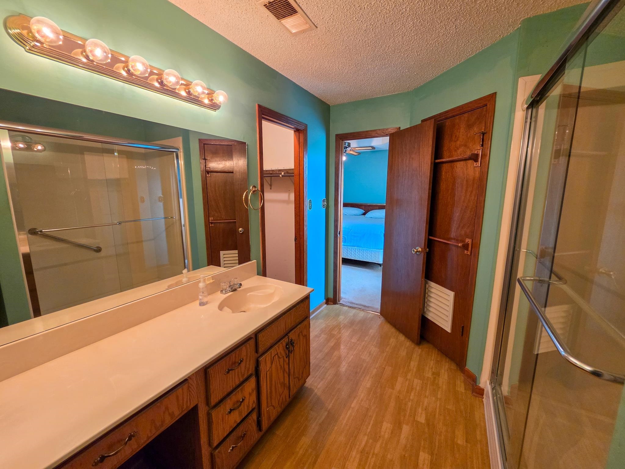 966 Beaver Road Munford, TN 38058 - Photo 12 of 32 Vanity area featuring a single basin, ample countertop space, and wood-finish cabinetry