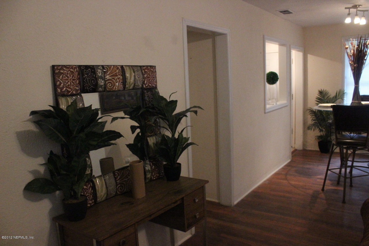 4525 Sunderland Road Jacksonville, FL 32210 - Photo 20 of 35 a view of a workspace with furniture and entryway with wooden floor