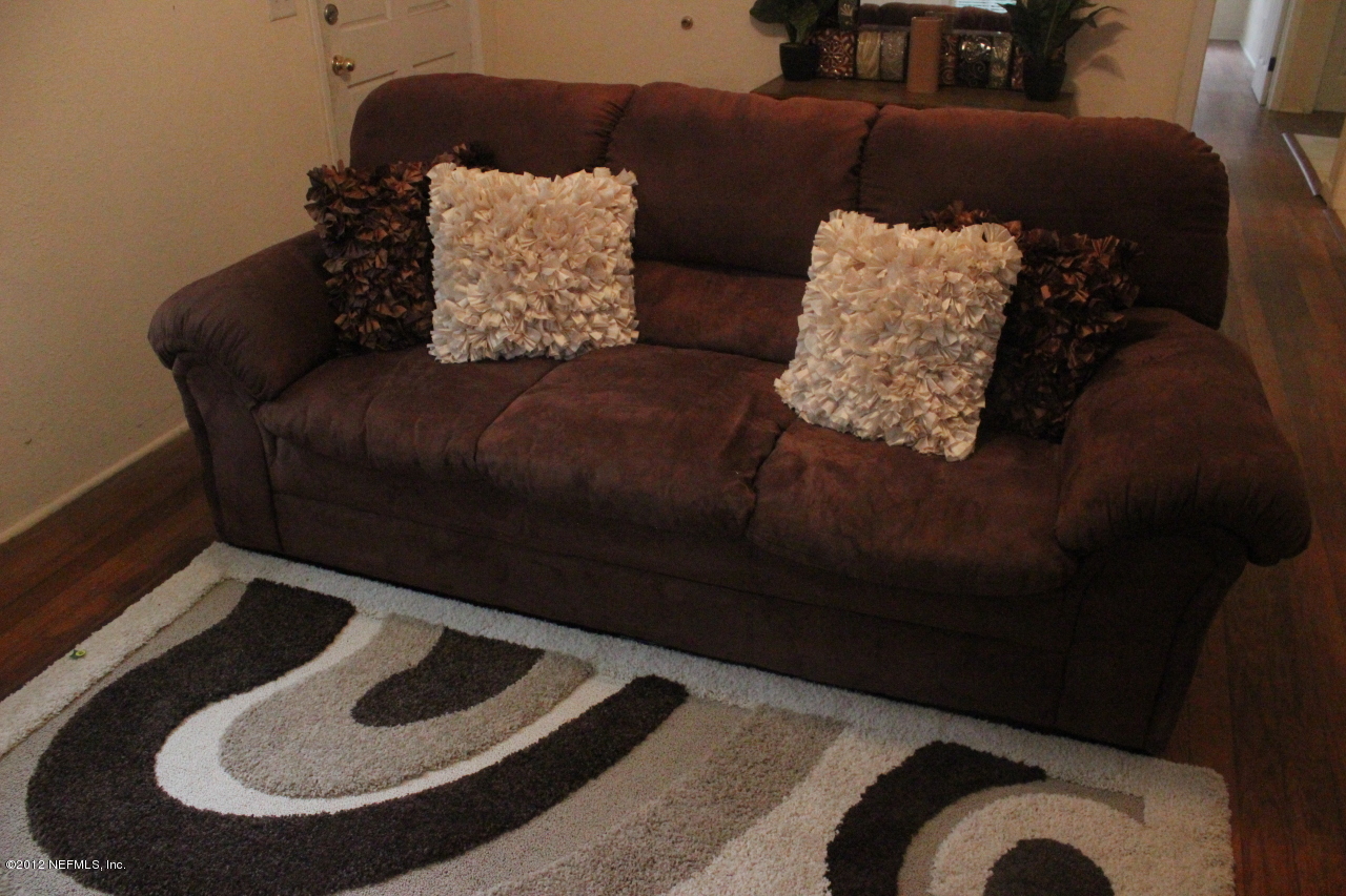 4525 Sunderland Road Jacksonville, FL 32210 - Photo 25 of 35 a living room with furniture and a rug