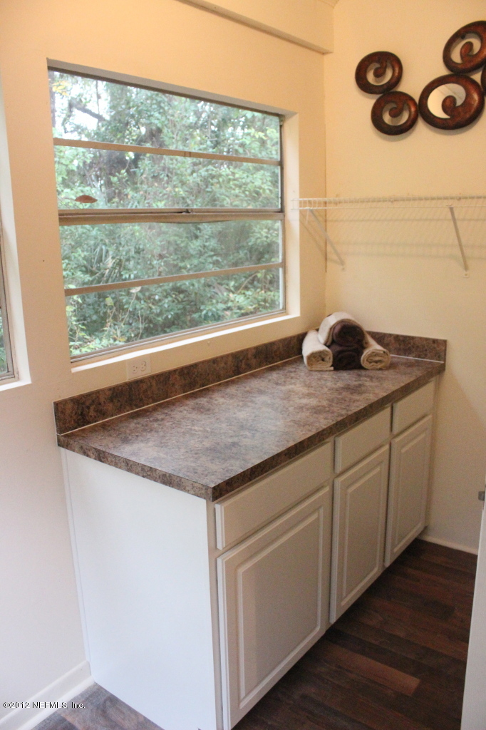 4525 Sunderland Road Jacksonville, FL 32210 - Photo 29 of 35 a kitchen with a granite countertop sink and window