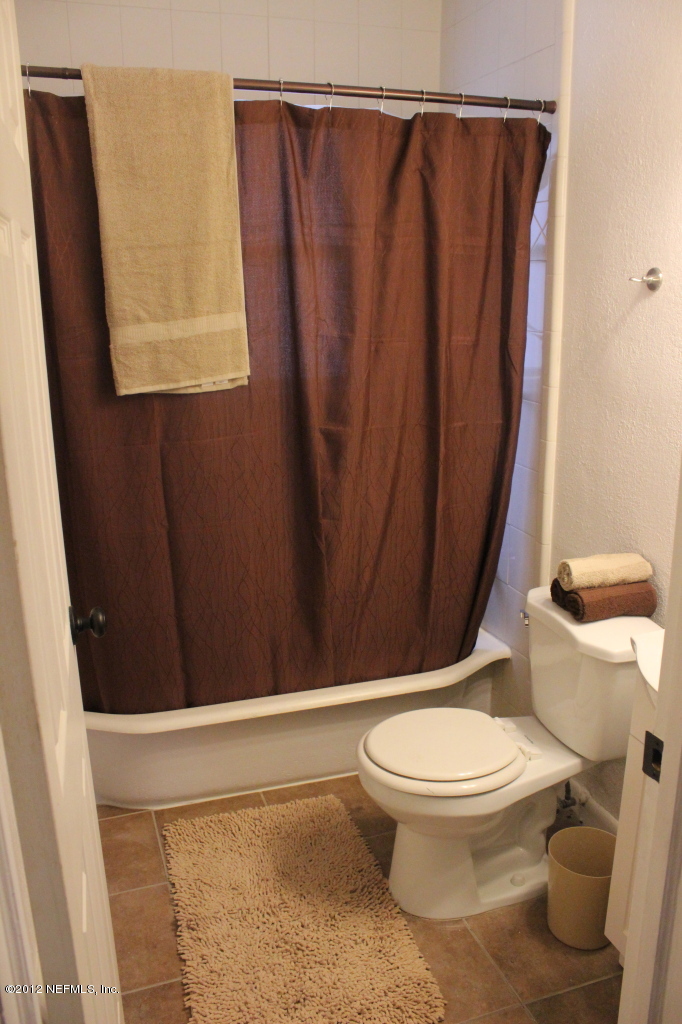 4525 Sunderland Road Jacksonville, FL 32210 - Photo 31 of 35 a white toilet sitting next to a shower