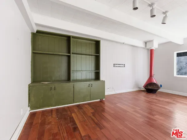 a view of a room with wooden floor and cabinet