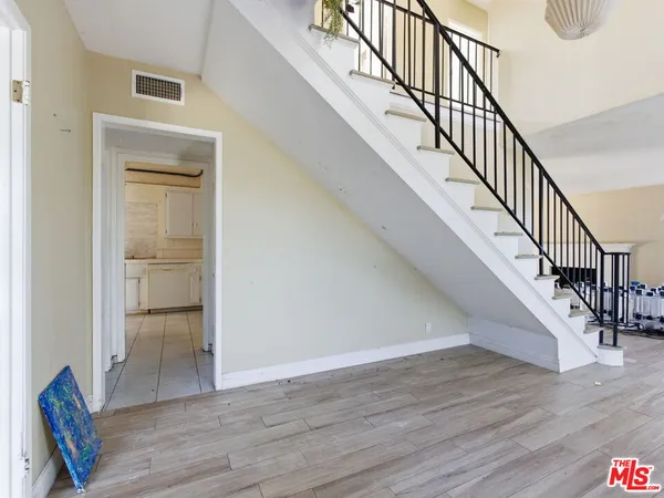 a view of entryway and hall with wooden floor