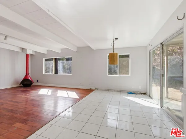 a view of an empty room with glass door