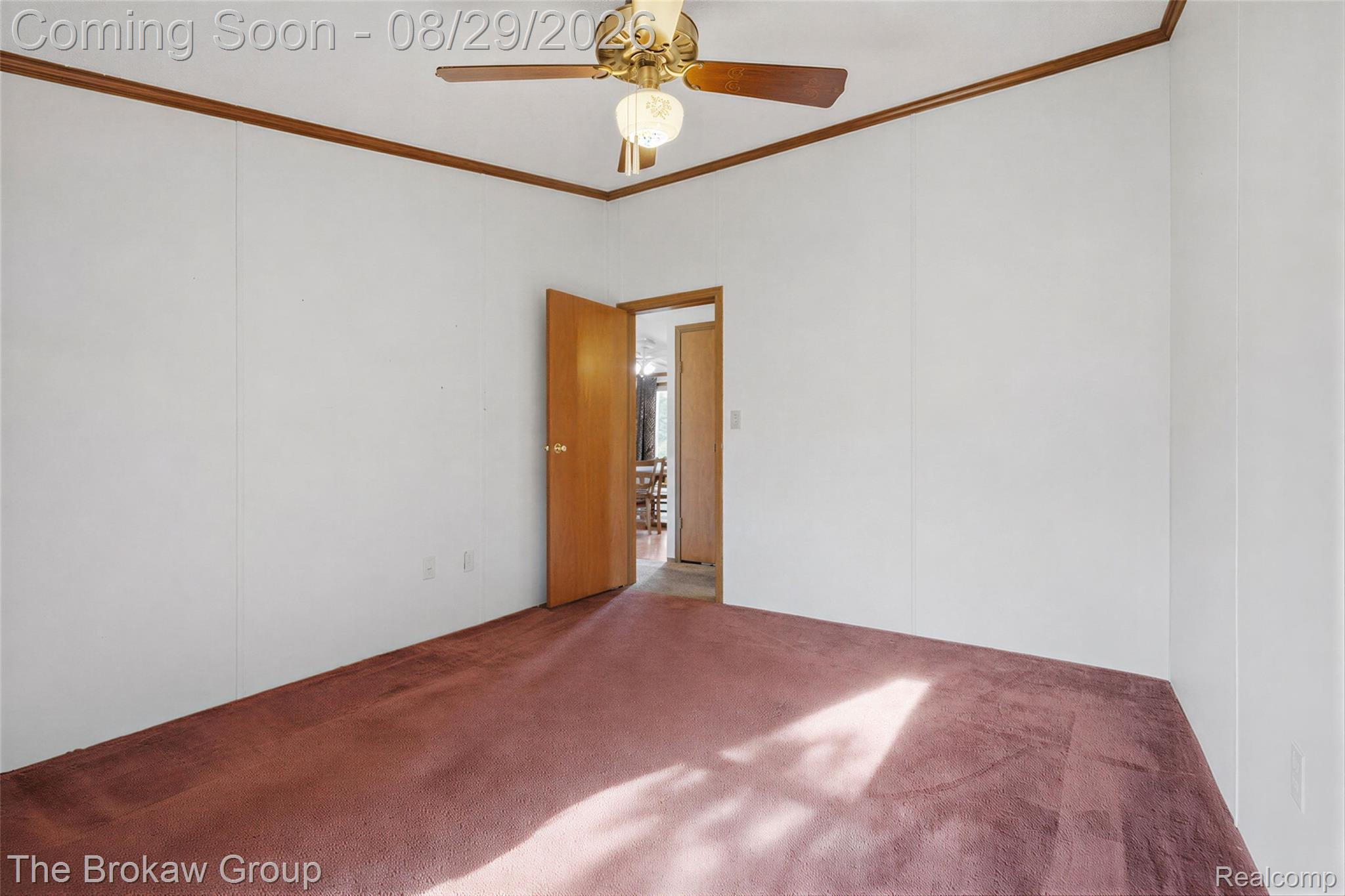 5189 North Webster Road Flushing, MI 48433 - Photo 23 of 46 Carpeted flooring, white walls with vertical paneling, and a ceiling fan with light fixture
