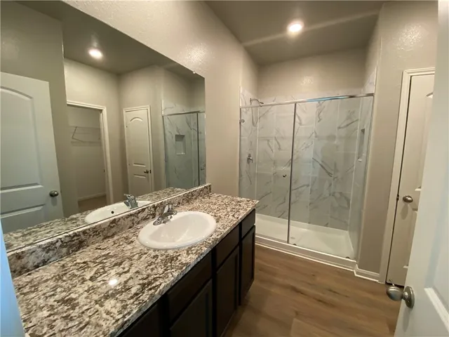 a bathroom with a glass shower door