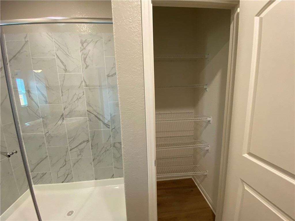 113 Declaration Lane Liberty Hill, TX 78642 - Photo 14 of 22 a bathroom with a glass shower door