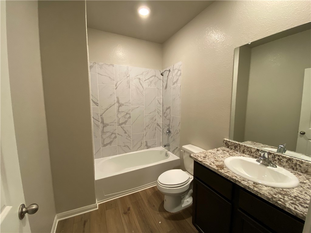 113 Declaration Lane Liberty Hill, TX 78642 - Photo 16 of 22 a bathroom with a granite countertop sink toilet and shower