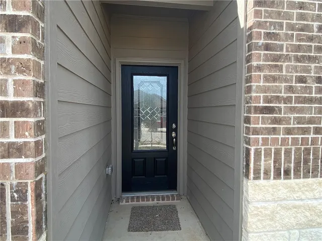 a kitchen with stainless steel appliances granite countertop a sink a stove top oven a refrigerator and dishwasher