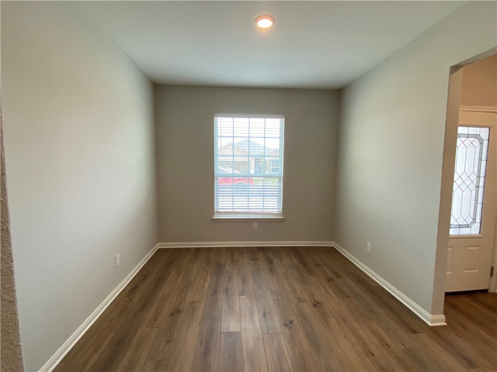 113 Declaration Lane Liberty Hill, TX 78642 - Photo 9 of 22 an empty room with wooden floor and windows