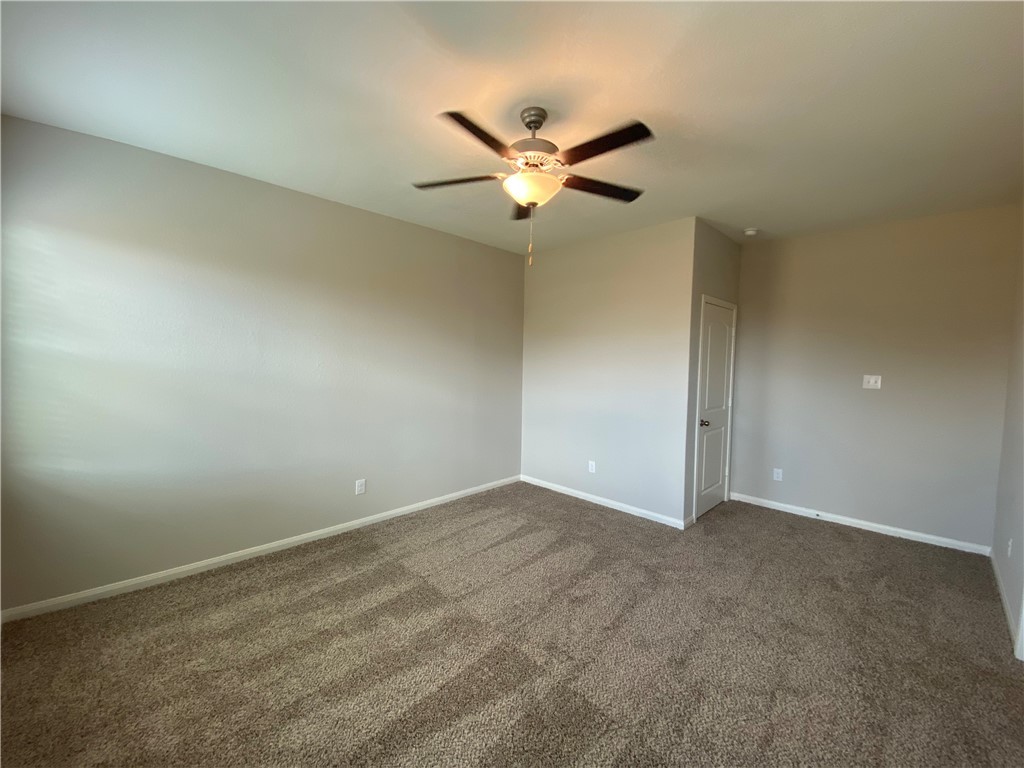 113 Declaration Lane Liberty Hill, TX 78642 - Photo 10 of 22 an empty room with a ceiling fan and a window