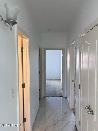 an empty room with windows and cabinet