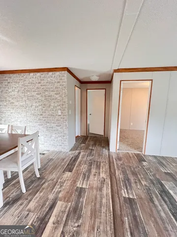 a view of a livingroom with wooden floor and chair