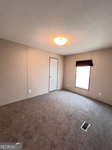 a view of an empty room and a window
