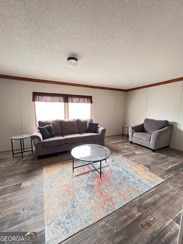a kitchen with granite countertop a stove top oven microwave and cabinets