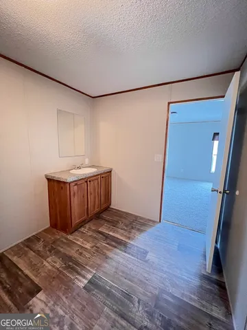 a view of a room with wooden floor